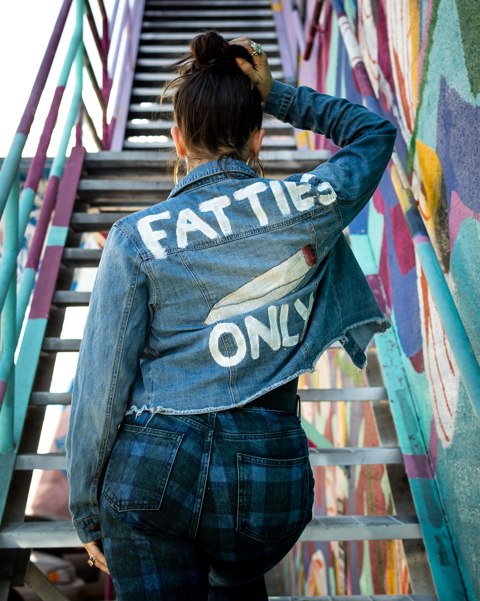 Onjha from Saints with a jean jacket that reads, "Fatties Only."