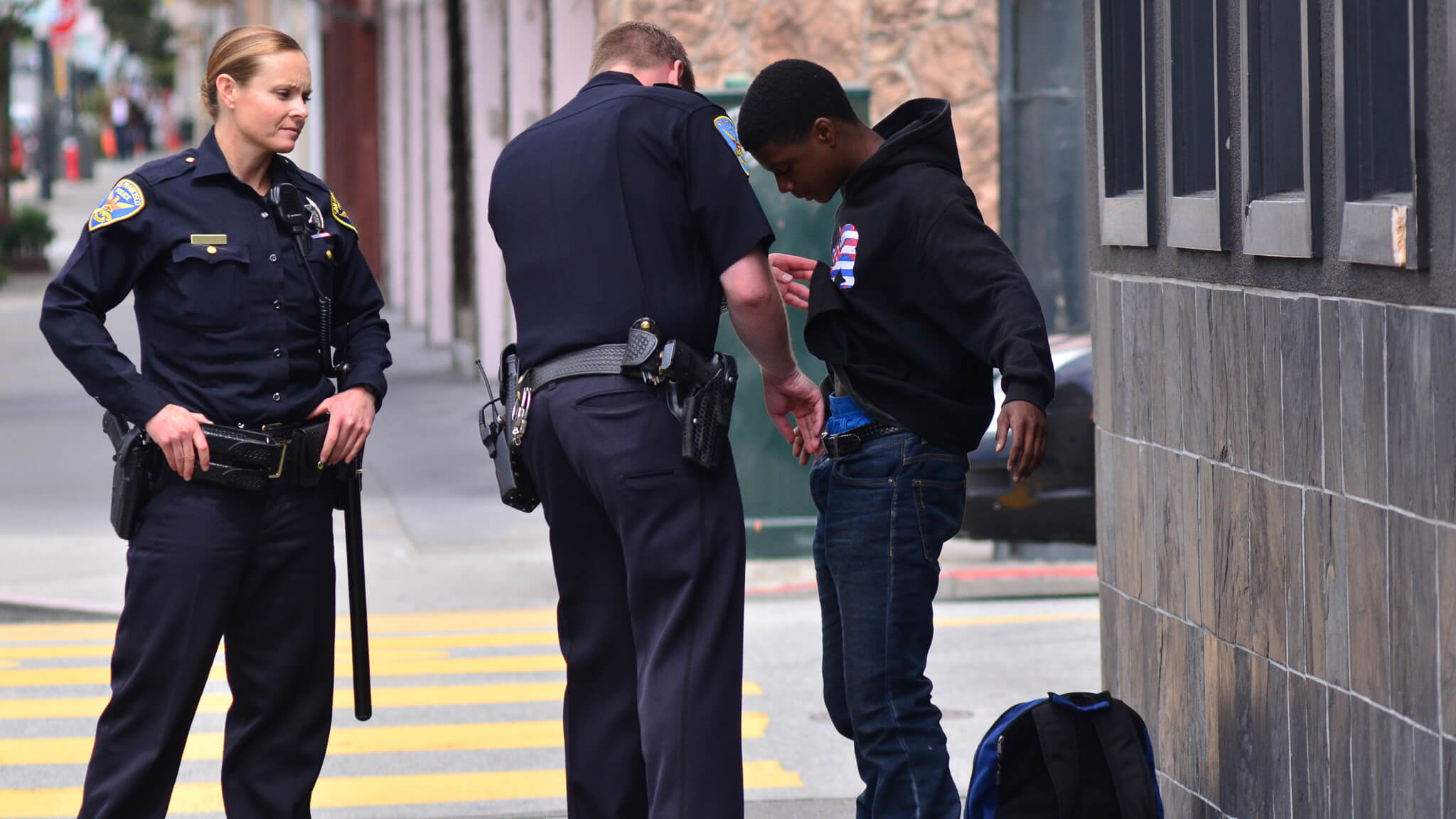 Police frisking a black teen