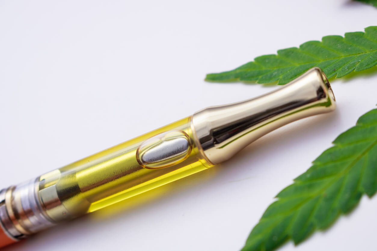 cannabis oil pen on cannabis leaf