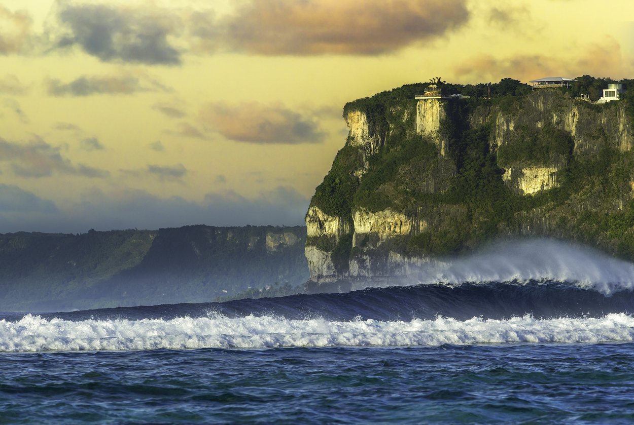 Wave breaking in front of Two Lovers Point, Guam during sunset.