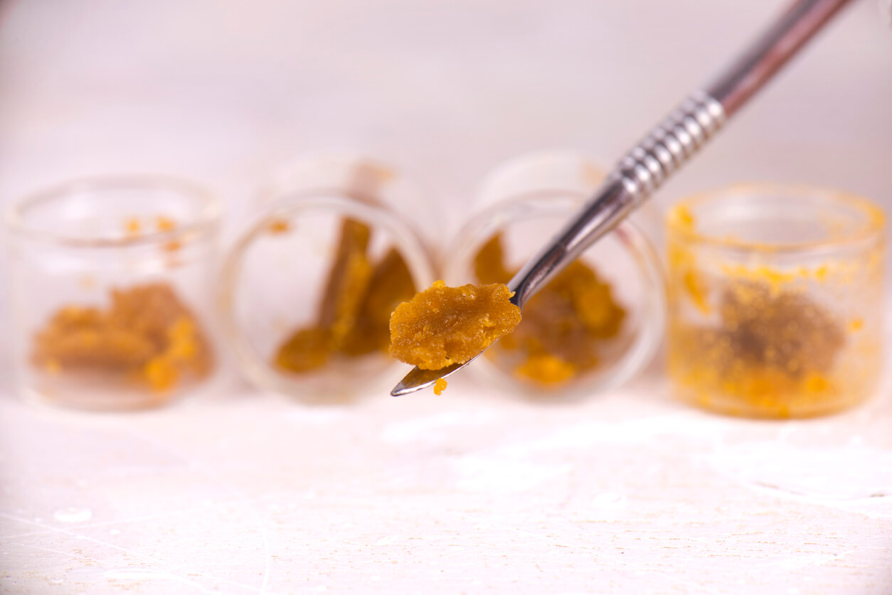 Macro detail of cannabis concentrate live resin (extracted from medical marijuana) isolated over white on a dabbing tool