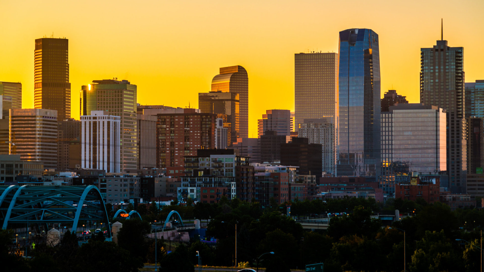 Orange Glow Sunrise in the Mile High City - Denver Colorado USA - Close up on Skyline Cityscape growing skyscrapers - golden hour sunrise glowing orange downtown