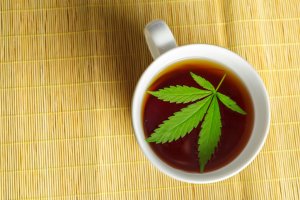 Cannabis herbal tea and marijuana leaves