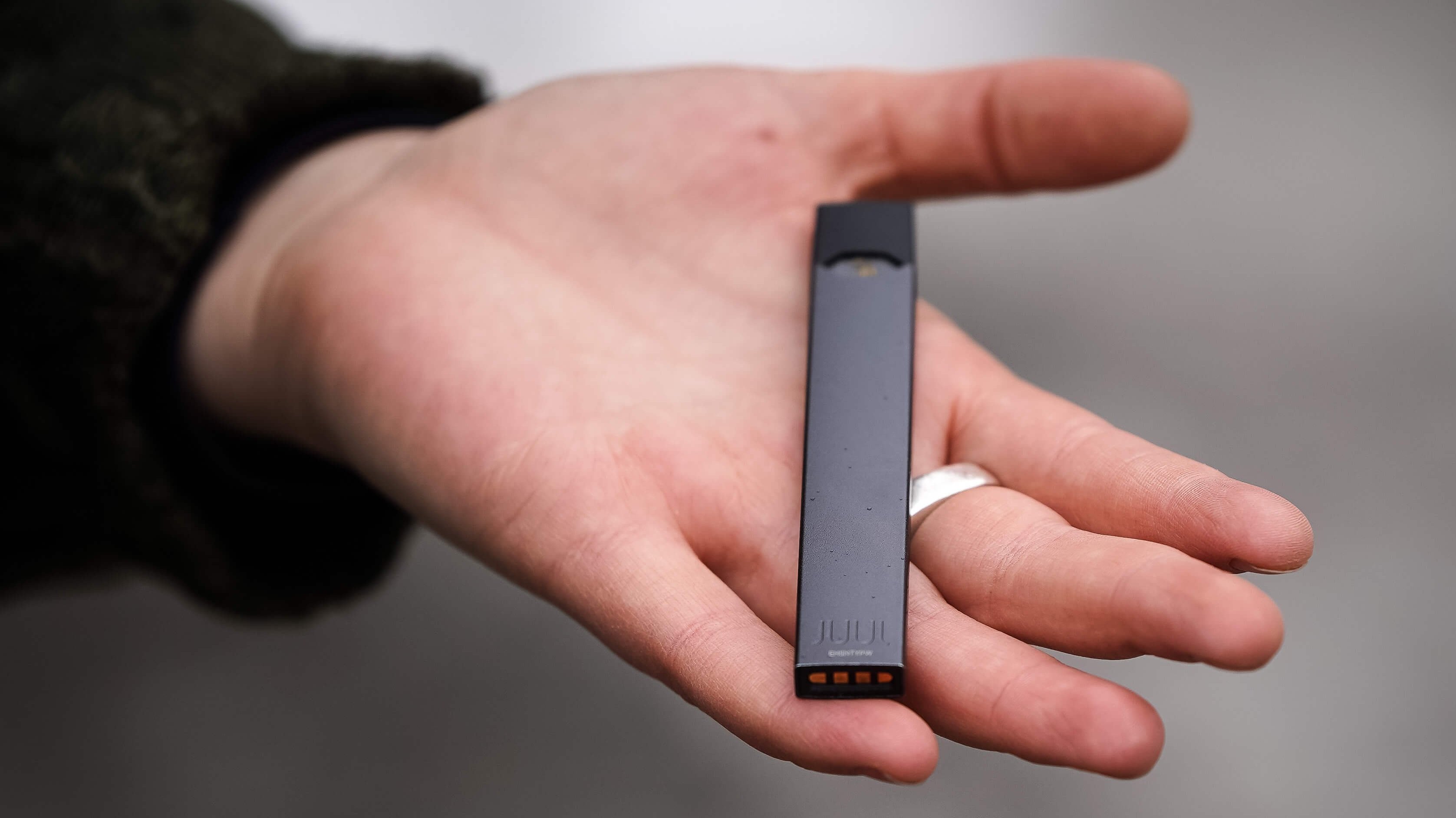 A woman is holding a Juul e-cigarette, in Montreal, vaping