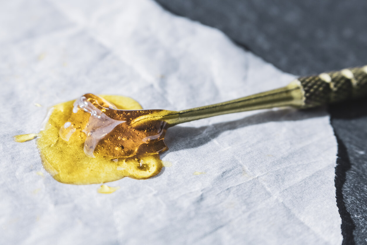 THC concentrated rosin isolated on wax paper with dab tool