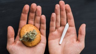 Hands holding a Cookie in one hand and a joint in the other