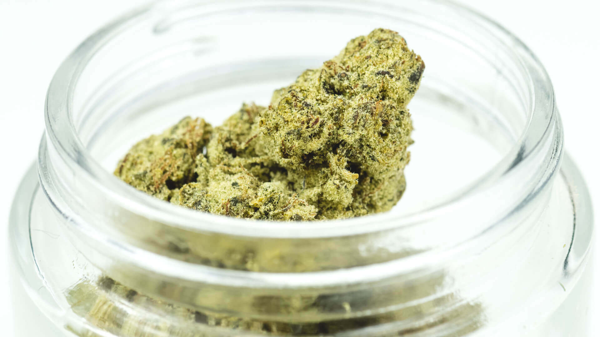 A glass jar full of moon rocks cannabis