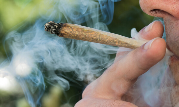 Closeup of a man smoking a joint