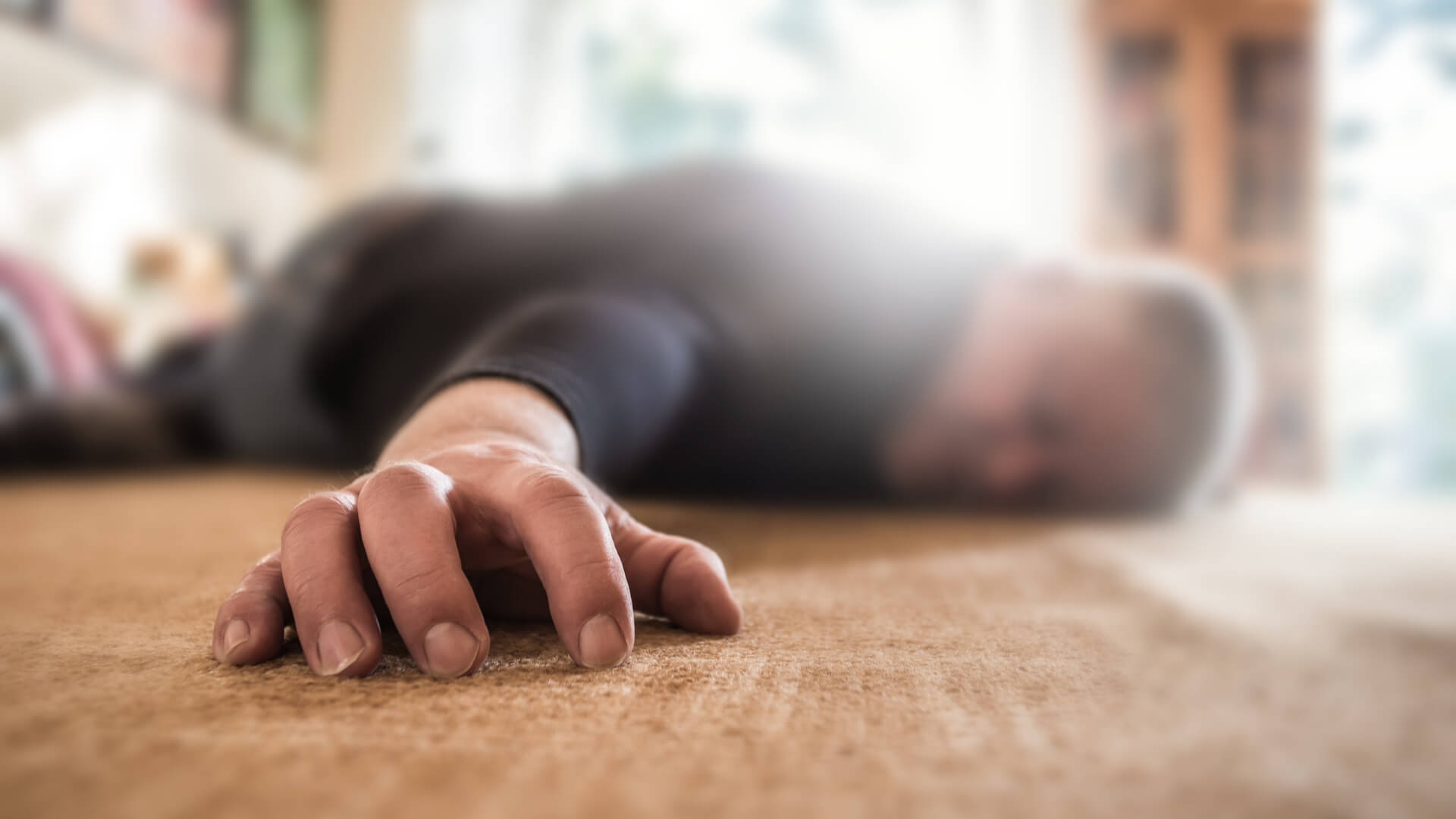 A man lies unconscious in his apartment