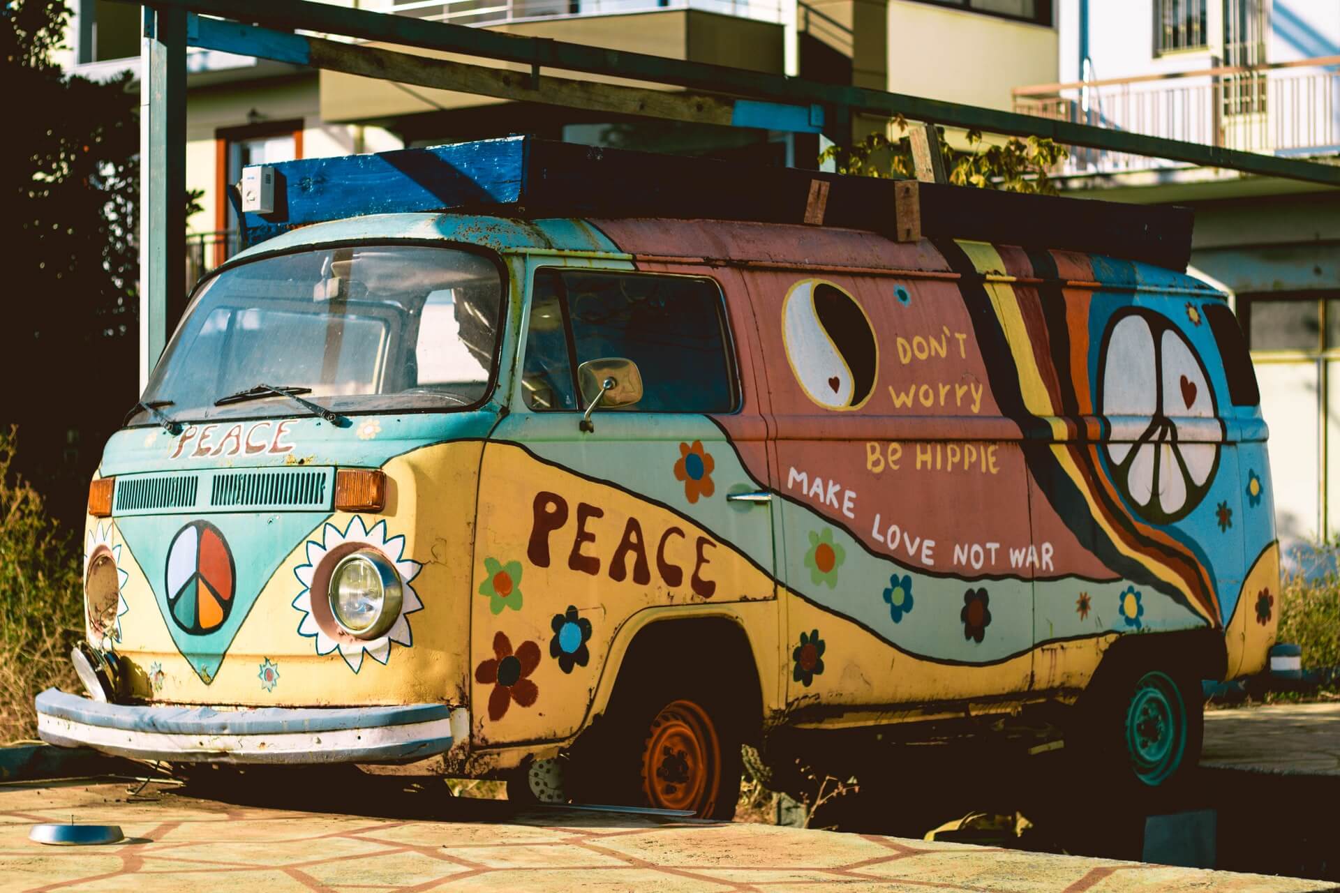 An old hippie van covered in colorful art