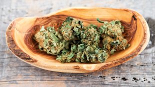 Closeup of marijuana buds in a wooden bowl
