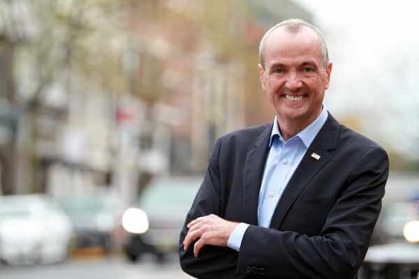 Image of New Jersey Governor Phil Murphy in a blue suit crossing his arms.