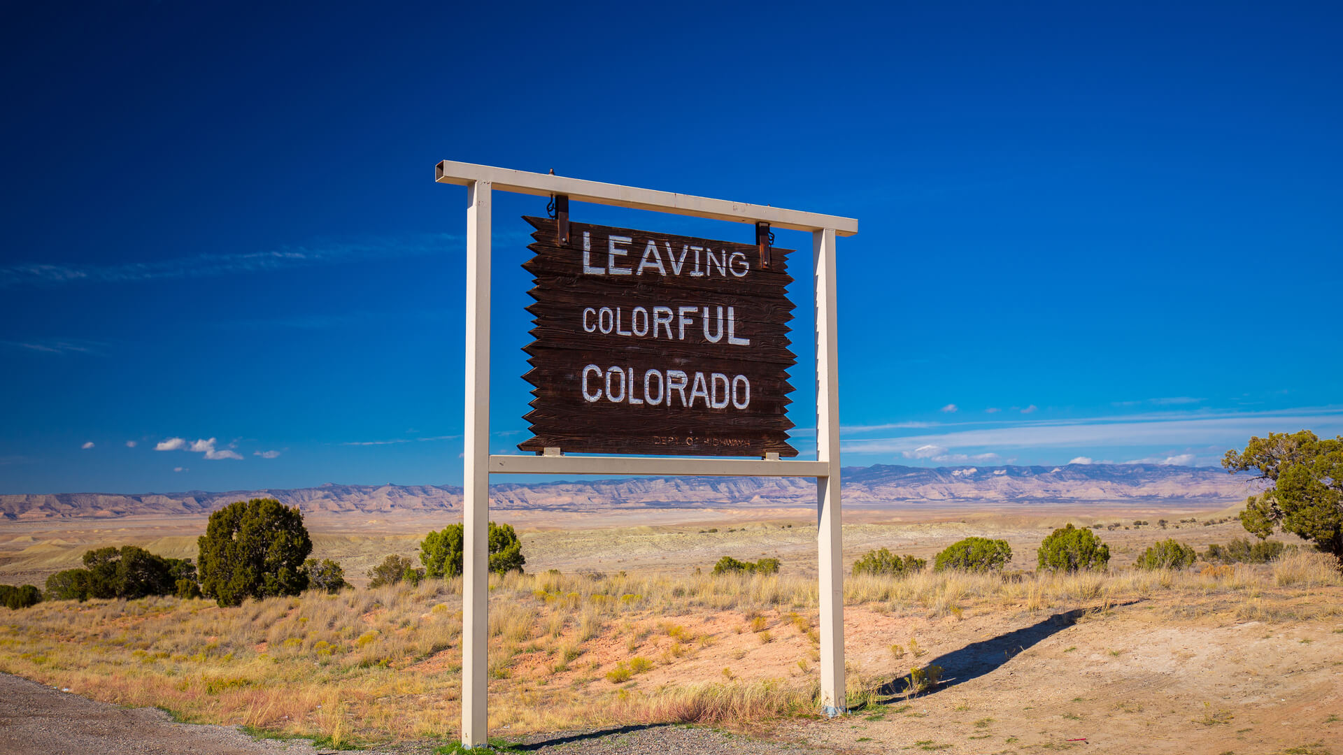 A wooden sign saying Leaving Colorful Colorado