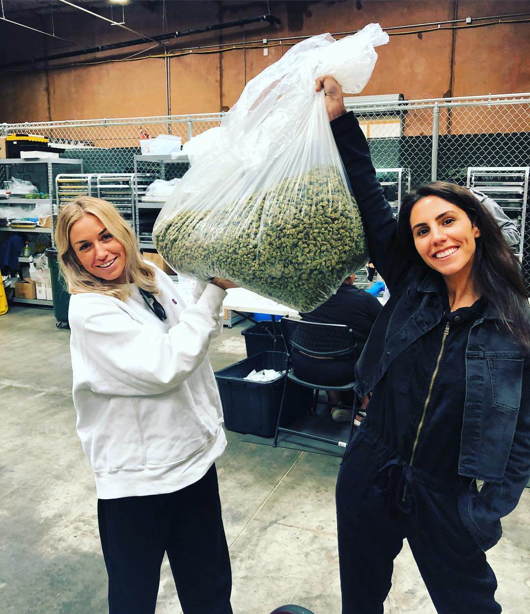 Kate Miller, the head of Miss Grass, holding a large bag of cannabis buds