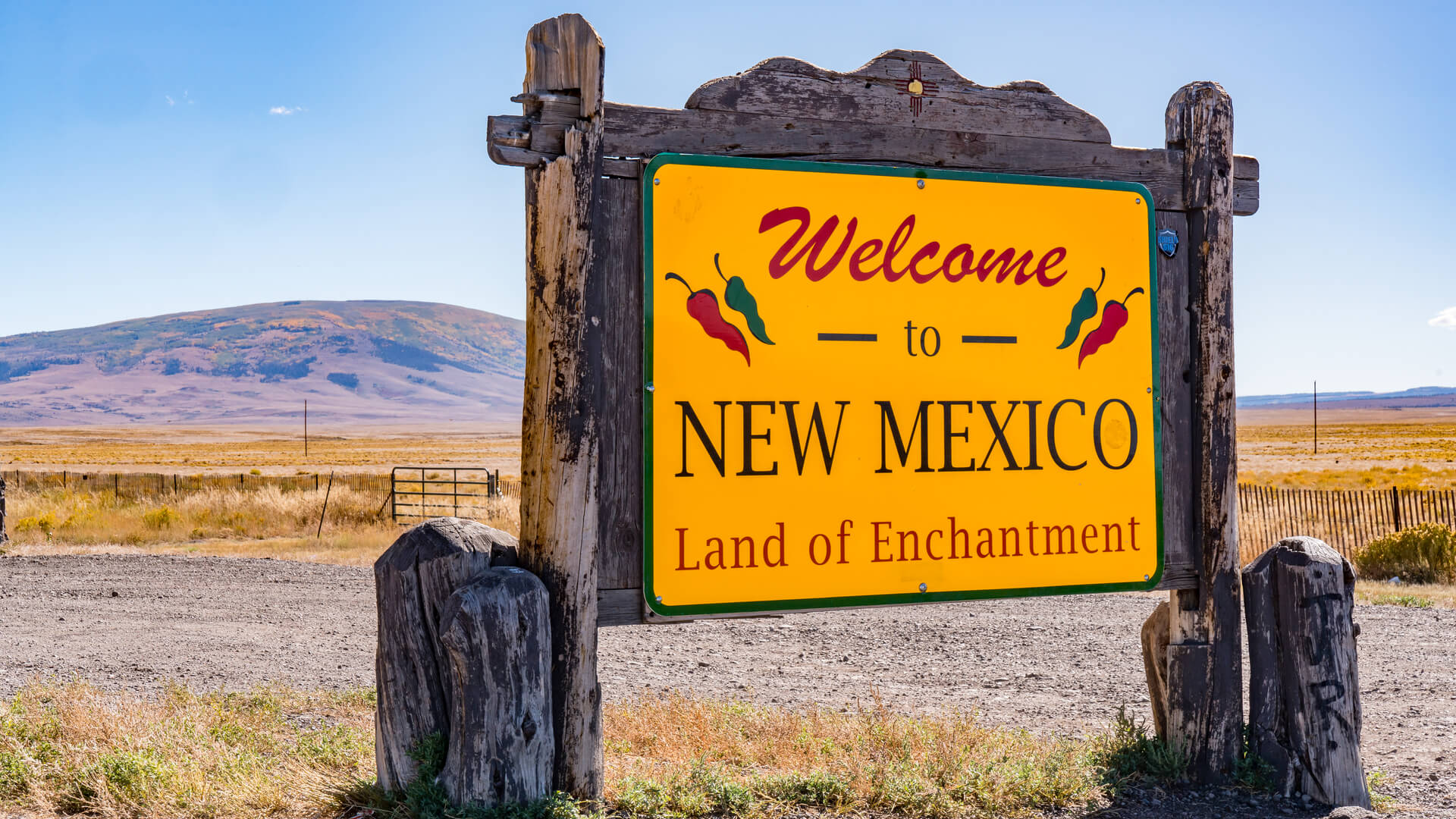 An orange sign welcoming visitors to New Mexico