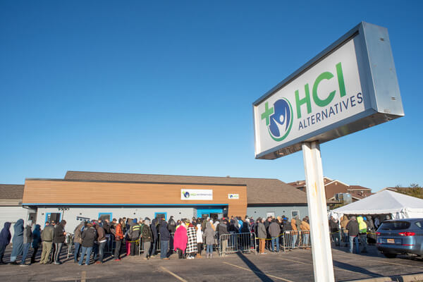 Hundreds wait in line at HCI Alternatives marijuana dispensary in Illinois