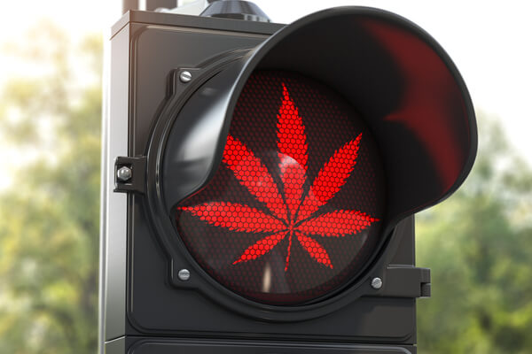 Cannabis leaf on red traffic light