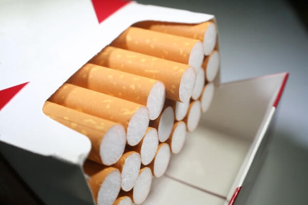 A red and white cigarette box opened with the orange bottoms showing 