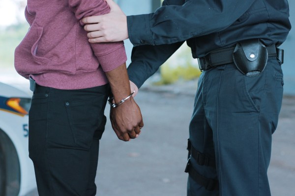Police man arresting a black man