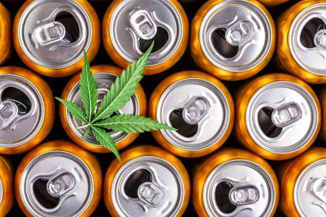 top of soda cans with a cannabis leaf on top